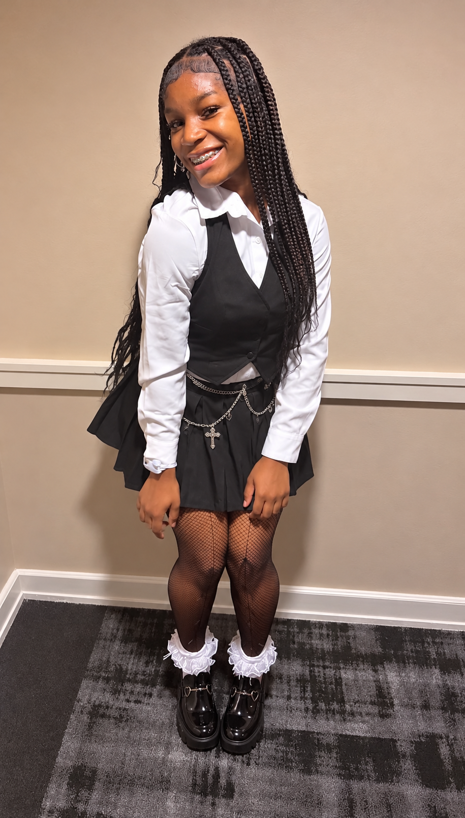 Jakailyn Hill smiling with braids and braces